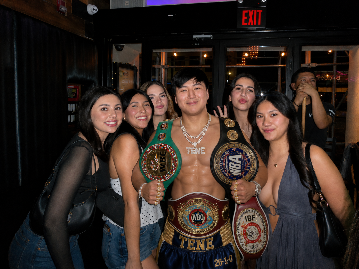 Champ Davis posing with fans and belts
